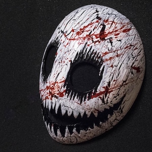 White smile mask with blood splatter