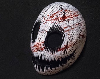 White smile mask with blood splatter
