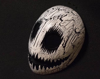 White smile mask with black cracks