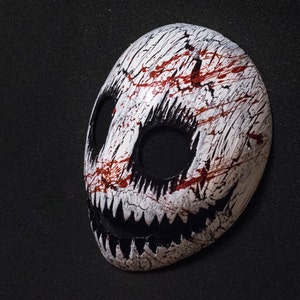 White smile mask with blood splatter