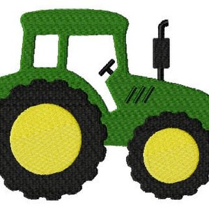 May include: A green toy tractor with black wheels and yellow centers. The tractor has a black exhaust pipe and a black steering wheel.