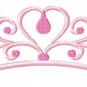 May include: A pink princess crown with a heart-shaped center and decorative swirls. The crown has several small pink jewels.