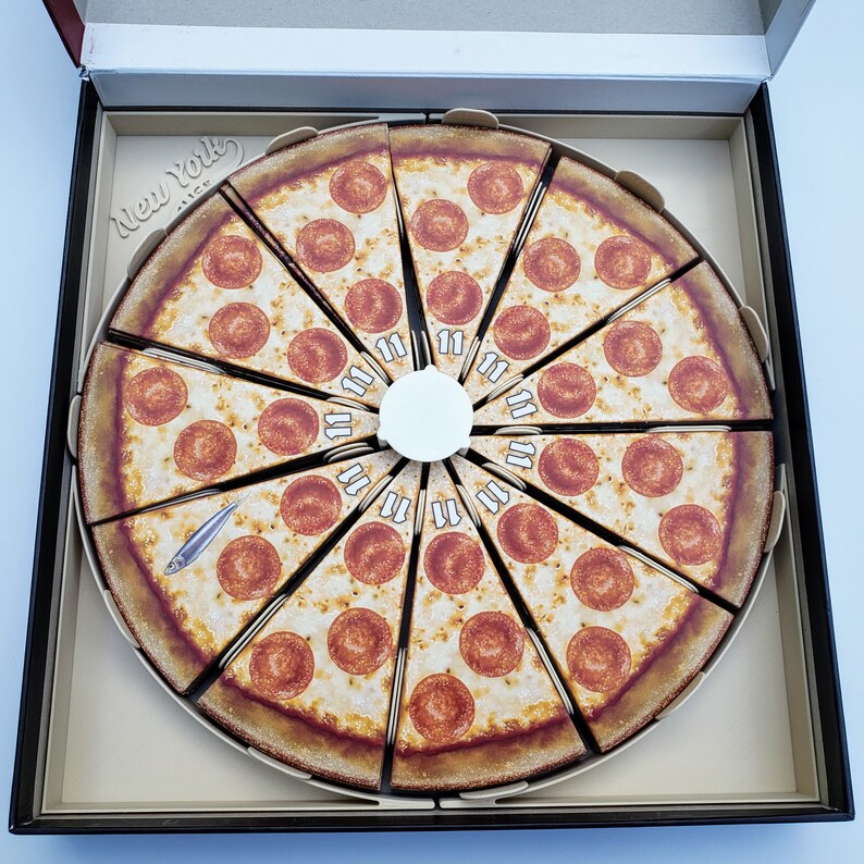 May include: A circular pizza pie divided into 12 slices, each with pepperoni and cheese. The pizza is in a box with the words "New York Slice" printed on the side.