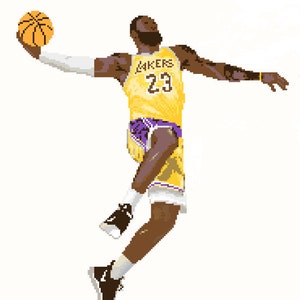 May include: A basketball player wearing a yellow and purple jersey with the number 23 and the word "LAKERS" on the front, is jumping in the air with a basketball in his hand.