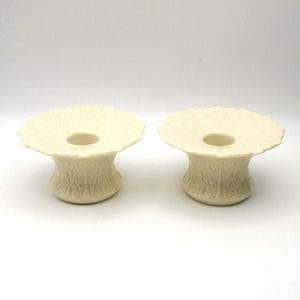 May include: A set of three ceramic mugs with a speckled, matte finish. The mugs are in shades of cream, light gray, and dark gray. Each mug has a simple, minimalist design, perfect for coffee or tea.