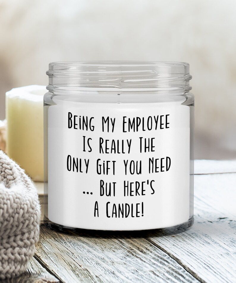 May include: A white candle in a clear glass jar with a black label that reads "Being my employee is really the only gift you need... but here's a candle!"
