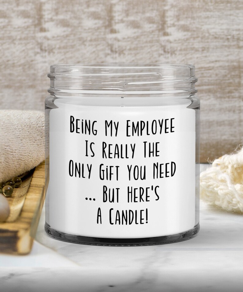 May include: A white candle in a glass jar with a black label that reads "Being my employee is really the only gift you need... but here's a candle!"