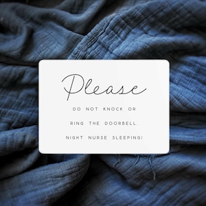 May include: A white rectangular sign with the word "Please" in elegant cursive script. Below, the text reads "DO NOT KNOCK OR RING THE DOORBELL. NIGHT NURSE SLEEPING!" The sign is set against a textured, blue fabric background.