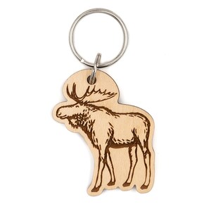 May include: A wooden moose keychain with a silver key ring. The moose is engraved in a light brown color.