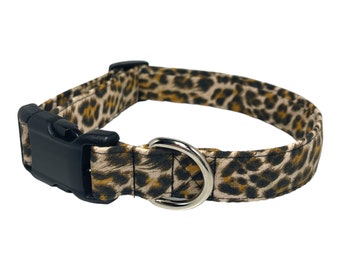 May include: A brown and black leopard print dog collar with a black plastic buckle and a silver metal D-ring.
