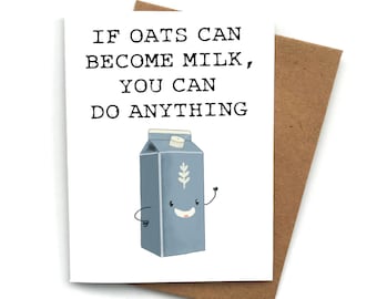 May include: A white card with the text "If oats can become milk, you can do anything."  A cartoon illustration of a carton of oat milk with a smiling face and arms is below the text. The card has a brown envelope behind it.