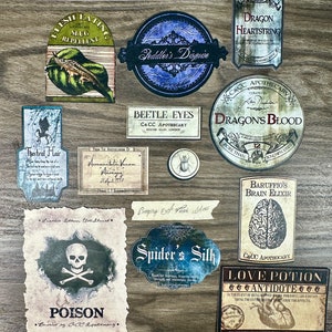 May include: A collection of vintage-style potion labels with illustrations and text. The labels feature names like "Dragon Heartstring", "Beetle Eyes", "Spider's Silk", and "Love Potion".