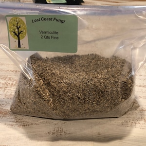 May include: A clear plastic bag filled with a light brown vermiculite, labeled "Lost Coast Fungi" and "Vermiculite 2 Qts Fine".