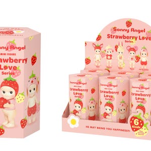 May include: A pink hexagonal box and a matching display stand featuring the Sonny Angel Strawberry Love Series. The packaging is decorated with strawberry illustrations and text that reads Sonny Angel Mini Figure Strawberry Love Series.