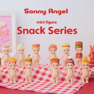 May include: A collection of Sonny Angel mini figures from the Snack Series. Each figure is nude with a different food-themed hat, including burgers, fries, and ice cream. The figures are arranged on a red and white checkered cloth.