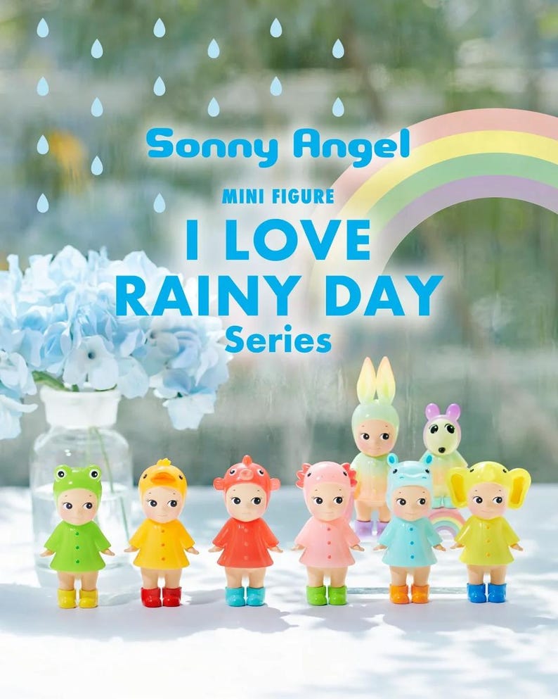 May include: A selection of Sonny Angel mini figures from the "I Love Rainy Day" series. Each figure is dressed in a colourful raincoat and wellington boots, with animal-themed hats. A rainbow and text are in the background.
