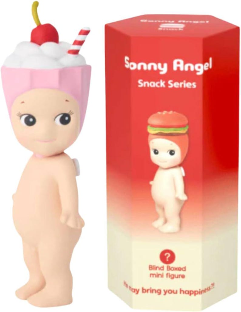 May include: A Sonny Angel mini figure from the Snack Series, featuring a pink and white milkshake hat with a cherry and straw. The figure is next to a red box with the series name and a burger-themed figure illustration.