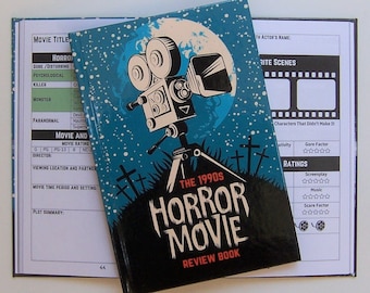 May include: A blue and black hardcover book with a vintage camera illustration and the text "The 1990s Horror Movie Review Book". The book is open to a page with a checklist for rating horror movies.