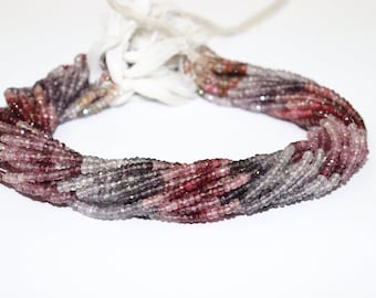 May include: A strand of pink, purple, and gray gemstone beads. The beads are faceted and have a slightly irregular shape. The strand is approximately 16 inches long.
