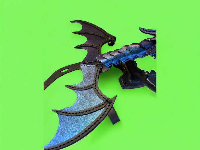 May include: A black leather dragon wing with iridescent blue and purple accents. The wing is attached to a black stand.