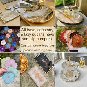 May include: A selection of decorative trays, coasters, and lazy susans. The items are in various shapes and colours, including round, rectangular, and flower-shaped designs. The text in the image reads: "All trays, coasters, & lazy susans have non-slip bumpers. Custom order inquiries- please message me."