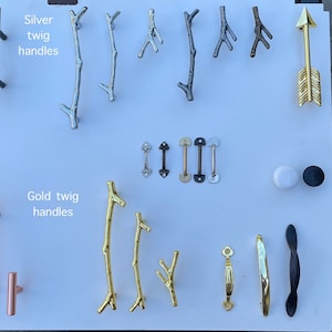 May include: Assortment of cabinet hardware, including silver and gold twig handles, black and gold pulls, and a gold arrow.  The text "Silver twig handles" and "Gold twig handles" is visible in the image.