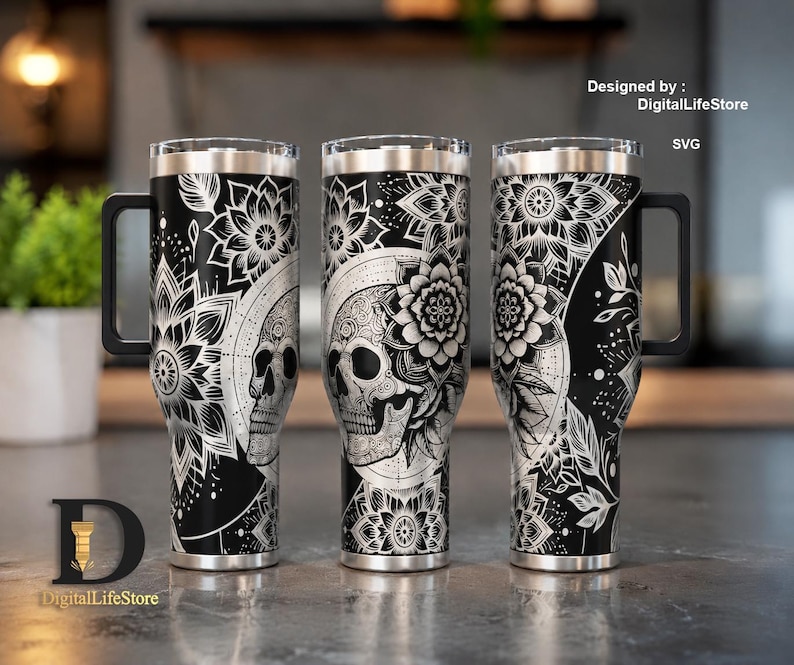 May include: Three black stainless steel tumblers with intricate white floral and skull designs. Each tumbler has a black handle and a silver rim. The design includes the text "Designed by: DigitalLifeStore SVG".