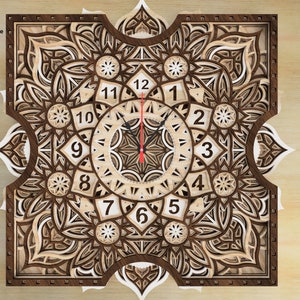 May include: A wooden clock with a mandala design. The clock face is white with black numbers and hands. The clock is surrounded by a intricate mandala pattern.