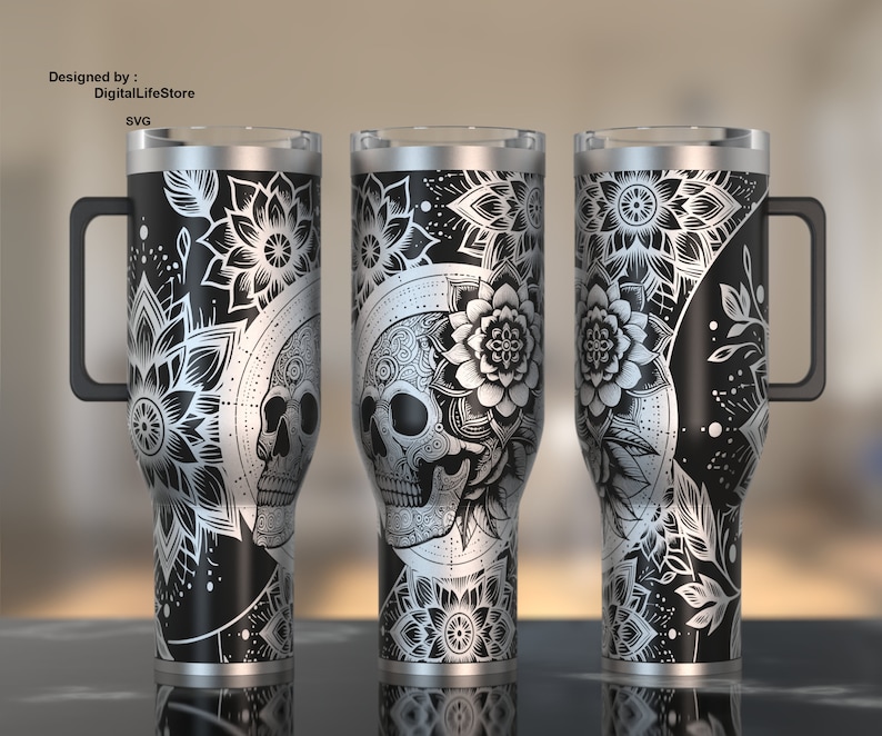 May include: Black and silver insulated tumbler with a skull and floral design. The tumbler has a handle and a clear lid. The design includes a skull, flowers, and mandala patterns. The text "Designed by : DigitalLifeStore SVG" is visible.