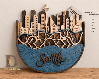 May include: A multi-layered wooden wall art piece depicting the Seattle skyline with the Space Needle, a mandala pattern, and blue water waves. The word Seattle is written in script. Text includes Designed by: DigitalLifeStore, SVG, DXF, AI, DWG, CDR.