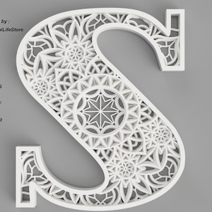 May include: White, intricate, laser cut letter S with a mandala design. The letter is cut out of a single piece of material, creating a delicate and detailed design.