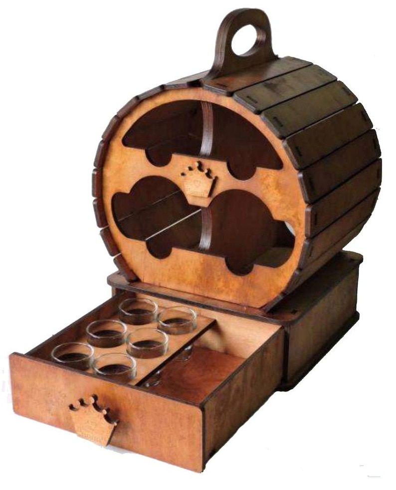 Puede incluir: Soporte de vasos de chupito de madera en forma de barril con un caj&oacute;n que se abre para revelar seis vasos de chupito. El soporte tiene un asa en la parte superior y un dise&ntilde;o de corona en la parte delantera.