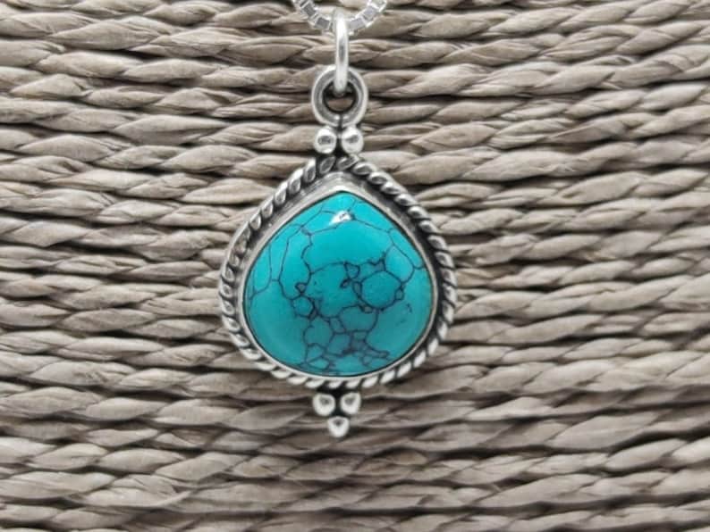 Silver pendant with turquoise stone.