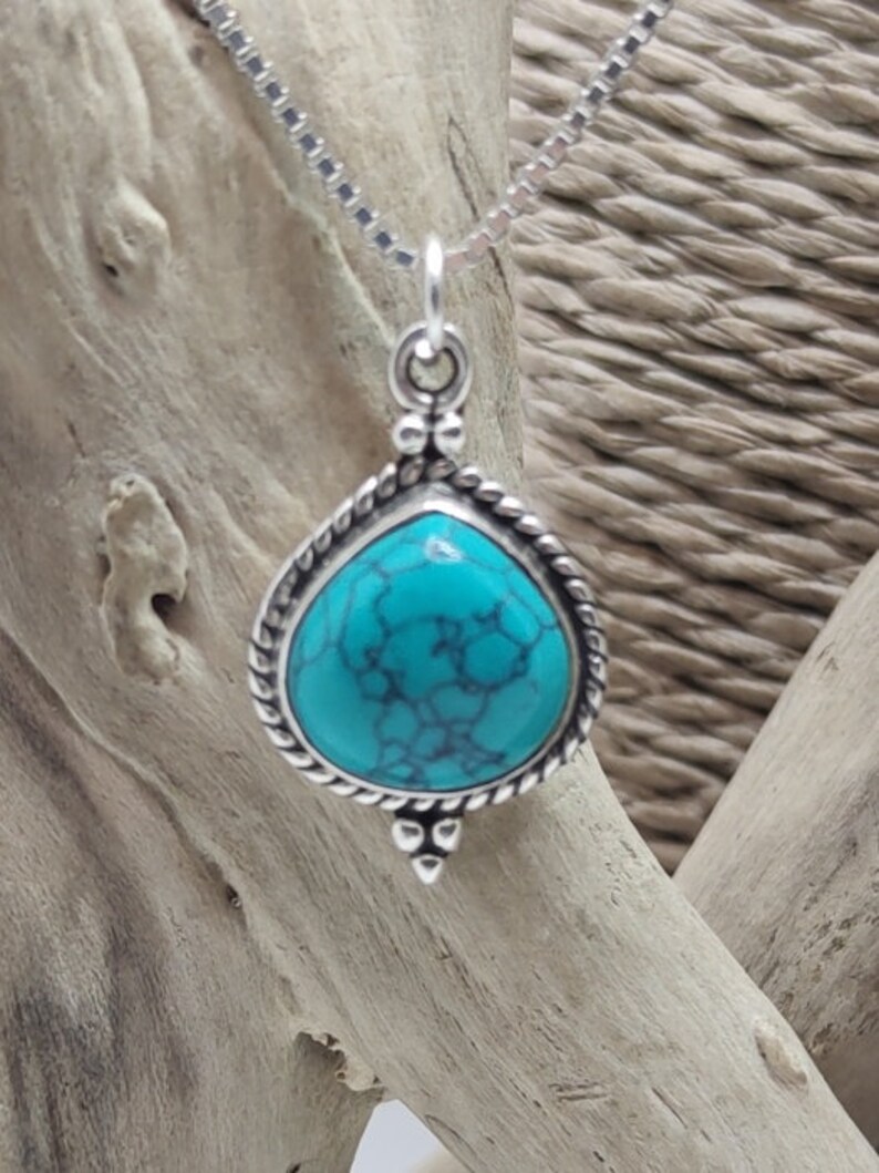 Silver pendant with turquoise stone.