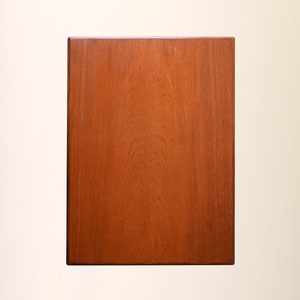 May include: A solid wood rectangular tabletop with a rich brown finish. The wood grain is visible and adds a natural texture to the surface.