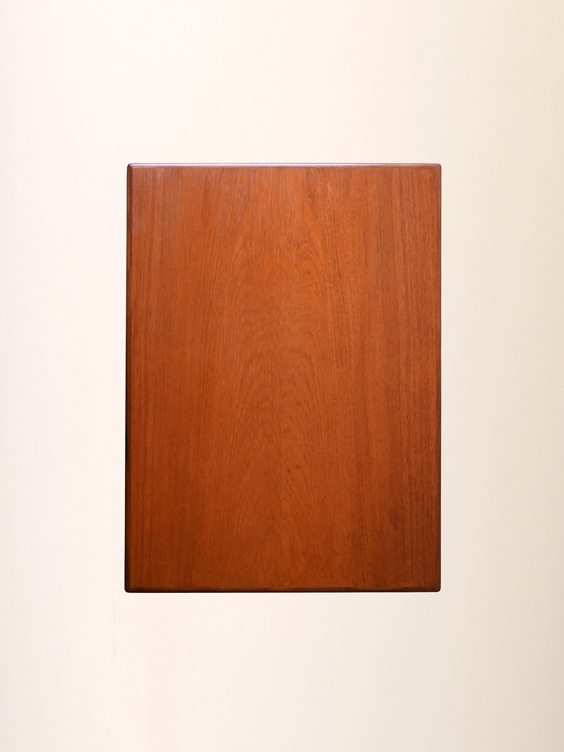 May include: A solid wood rectangular tabletop with a rich brown finish. The wood grain is visible and adds a natural texture to the surface.