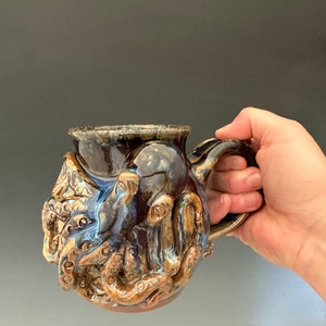 Handmade octopus stoneware mug.  Microwave/oven/dishwasher safe.