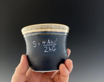 Etched stoneware ceramic tea cup. Hawkin’s formula for a black hole.