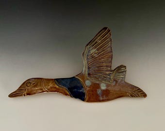 Handmade ceramic goose wall hanging. can be hung indoor or out.