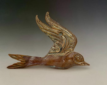 Wall hanging ceramic bird in flight. Can be hung indoors and outdoors