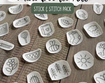 May include: A collection of small, white, adhesive fabric patches featuring black line art illustrations of various objects including a bee, a cactus, a watermelon slice, a sun, a flower, and a book, labeled Mini Doodle Art Stick & Stitch Pack.