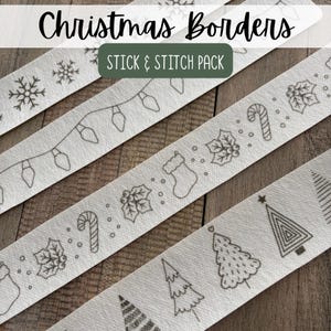 May include: A set of white fabric strips featuring black line art designs for embroidery, labeled Christmas Borders STICK & STITCH PACK. The patterns include snowflakes, string lights, candy canes, holly leaves, stockings, and various Christmas trees.
