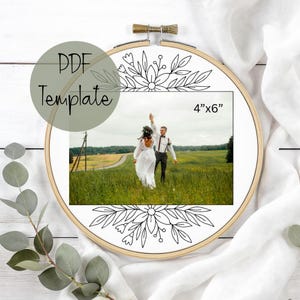 May include: A wooden embroidery hoop with a 10cm x 15cm photo of a wedding couple in a field. The hoop is decorated with a black and white floral design and the text "PDF Template".