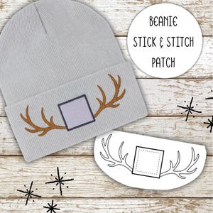 May include: A light gray beanie with a brown antler design and a square patch. The image also includes a matching stick and stitch patch with the text "Beanie Stick & Stitch Patch".