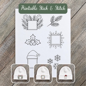 May include: A white sheet with black line art designs labeled Printable Stick & Stitch, featuring holiday motifs like candy canes, holly, pine branches, snowflakes, and a Santa hat. Three white beanies show these designs embroidered on them.