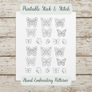 May include: A white sheet of paper with various hand-drawn butterfly designs in black ink. The words "Printable Stick & Stitch" and "Hand Embroidery Patterns" are printed on the paper.
