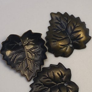 Brass stamped leaves with a bronze finish. ( 15 pieces per price)