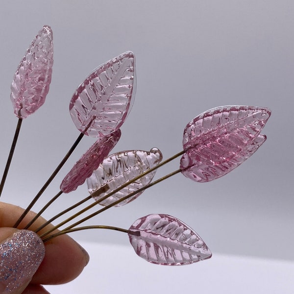 Ribbed pressed glass leaf with fused wire/eyepin.  20mm.  Transparent Pink. ( 14 peices per price)