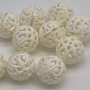 Delicate white filagree beads. Acrylic. (20 beads per price)