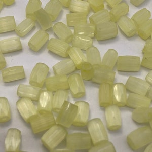 Facetted cut glass barrel beads.  6mm. Lime yellow ( 40 pieces per price)